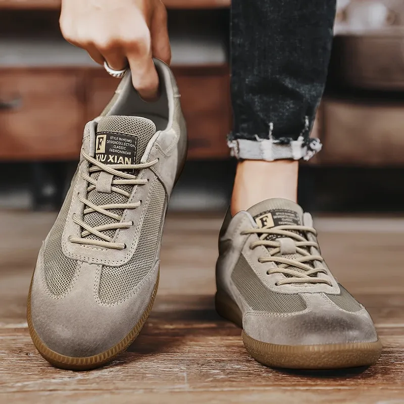 A person sits on a mini bike, showcasing Tiny Spark cargo pants with white, purple, and green stripe details, paired with white high-top sneakers.